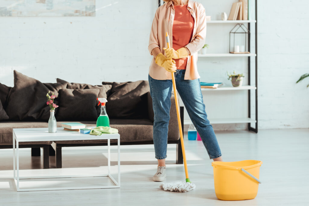 St. Pete Cleaning service Cropped view of woman cleaning house with mop and bucket