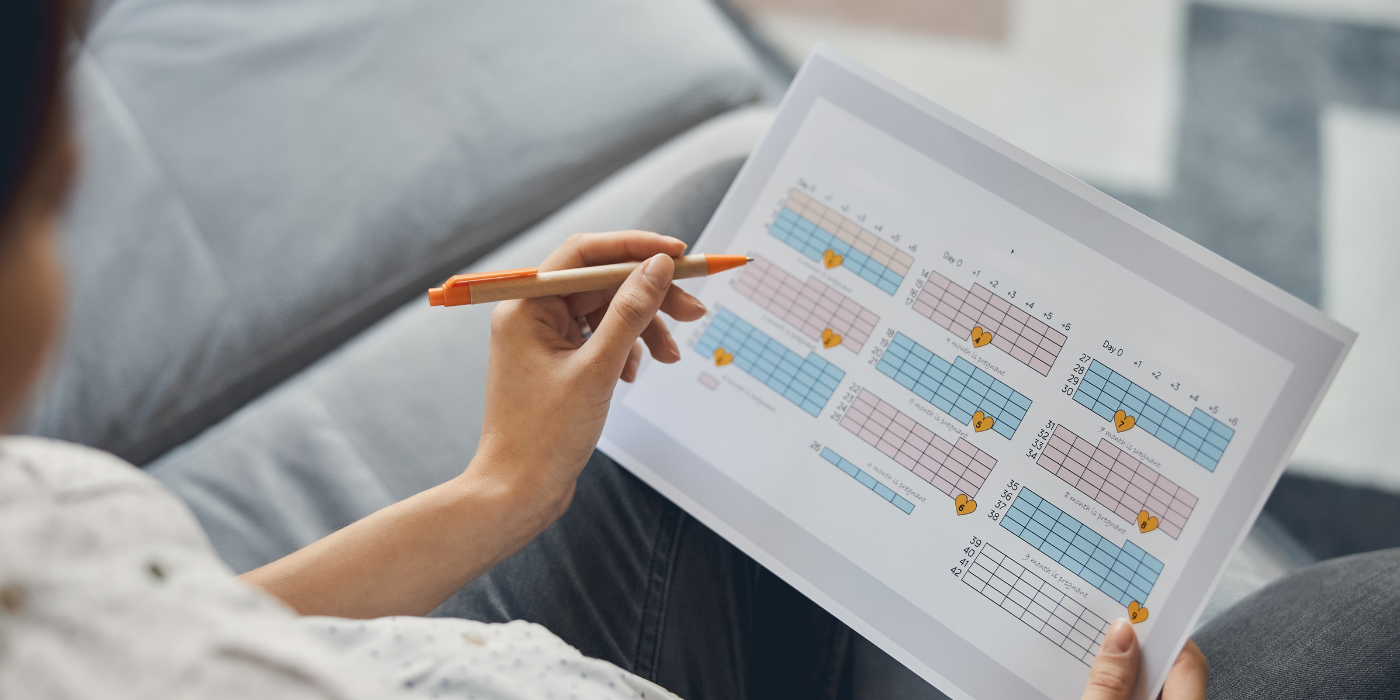How to Organize Your Cleaning Routine for Maximum Efficiency woman-ticking-dates-in-her-cleaning calendar