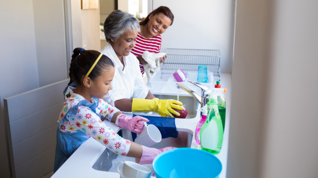 Quick Cleaning Hacks for Busy Families grandmother-and-granddaughter-washing-utensil-in-k