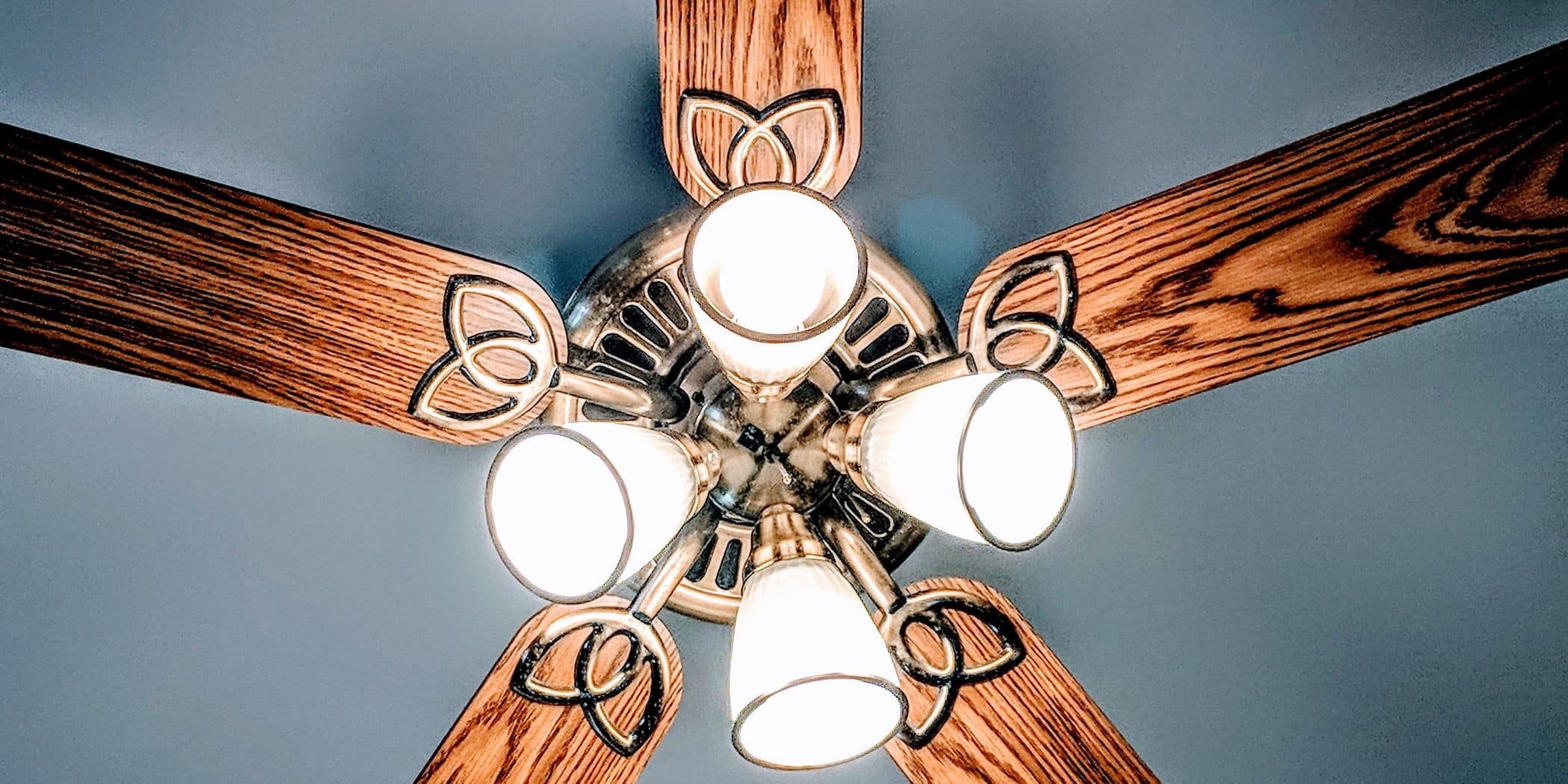 This Is How You Clean Your Ceiling Fans Without the Dust Storm